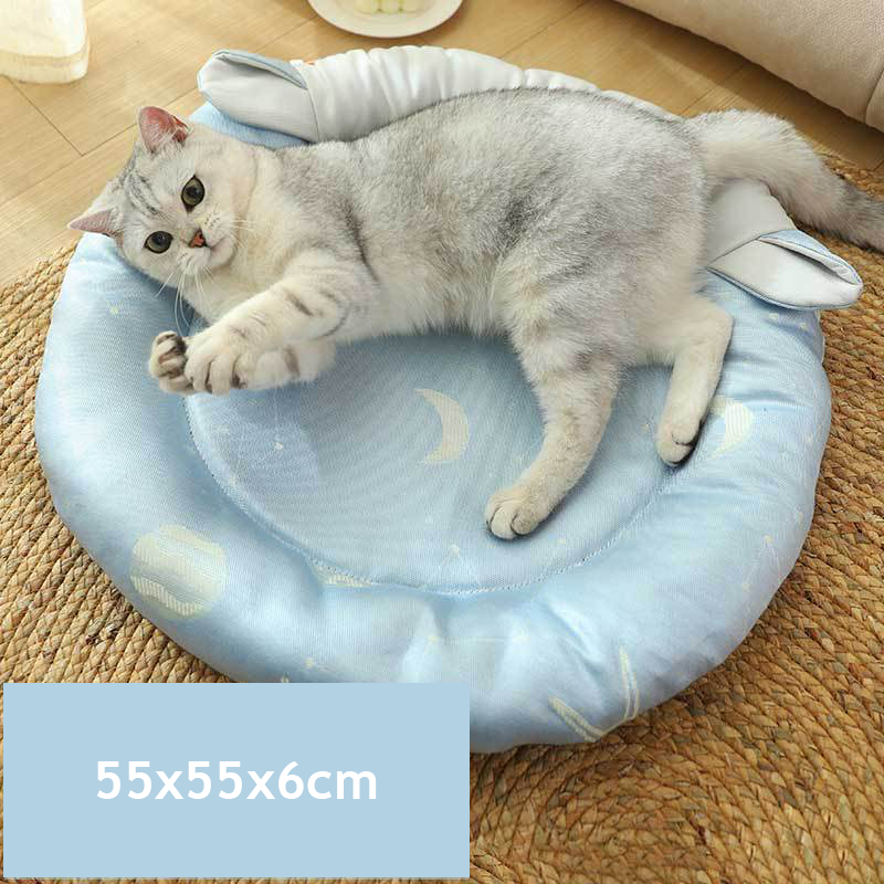 "Cat lying on blue cooling pet bed with moon and star design, size 55x55x6cm."