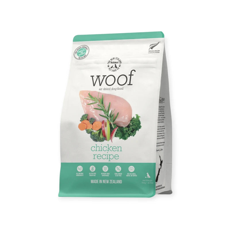 Front view of Woof Chicken Air-Dried Dog Food packaging with fresh chicken, kale, and carrots.