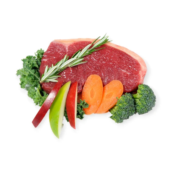 Fresh beef steak, broccoli, carrots, apple slices, and kale used in Woof Beef Dog Treats.
