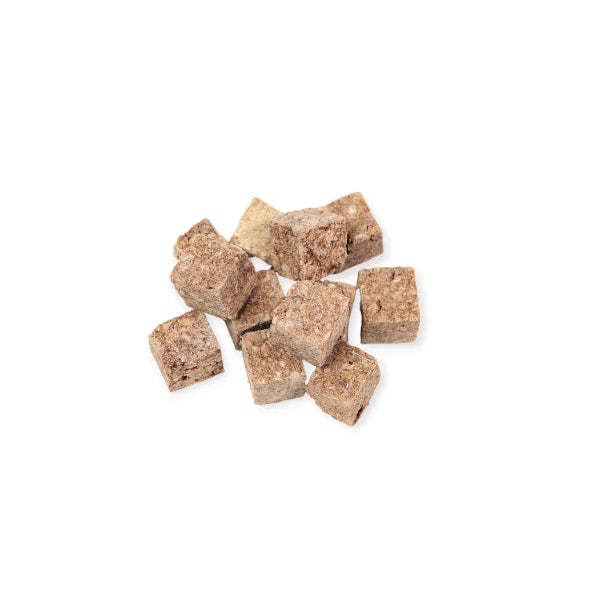 Close-up of freeze-dried Woof Wild Goat Treats, small cube-shaped snacks perfect for dogs.