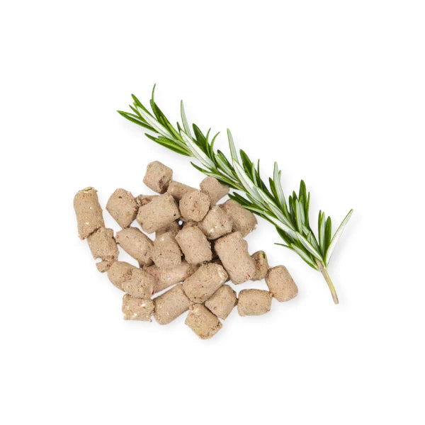 Freeze-dried Woof Lamb Treats in pellet form with rosemary sprig.
